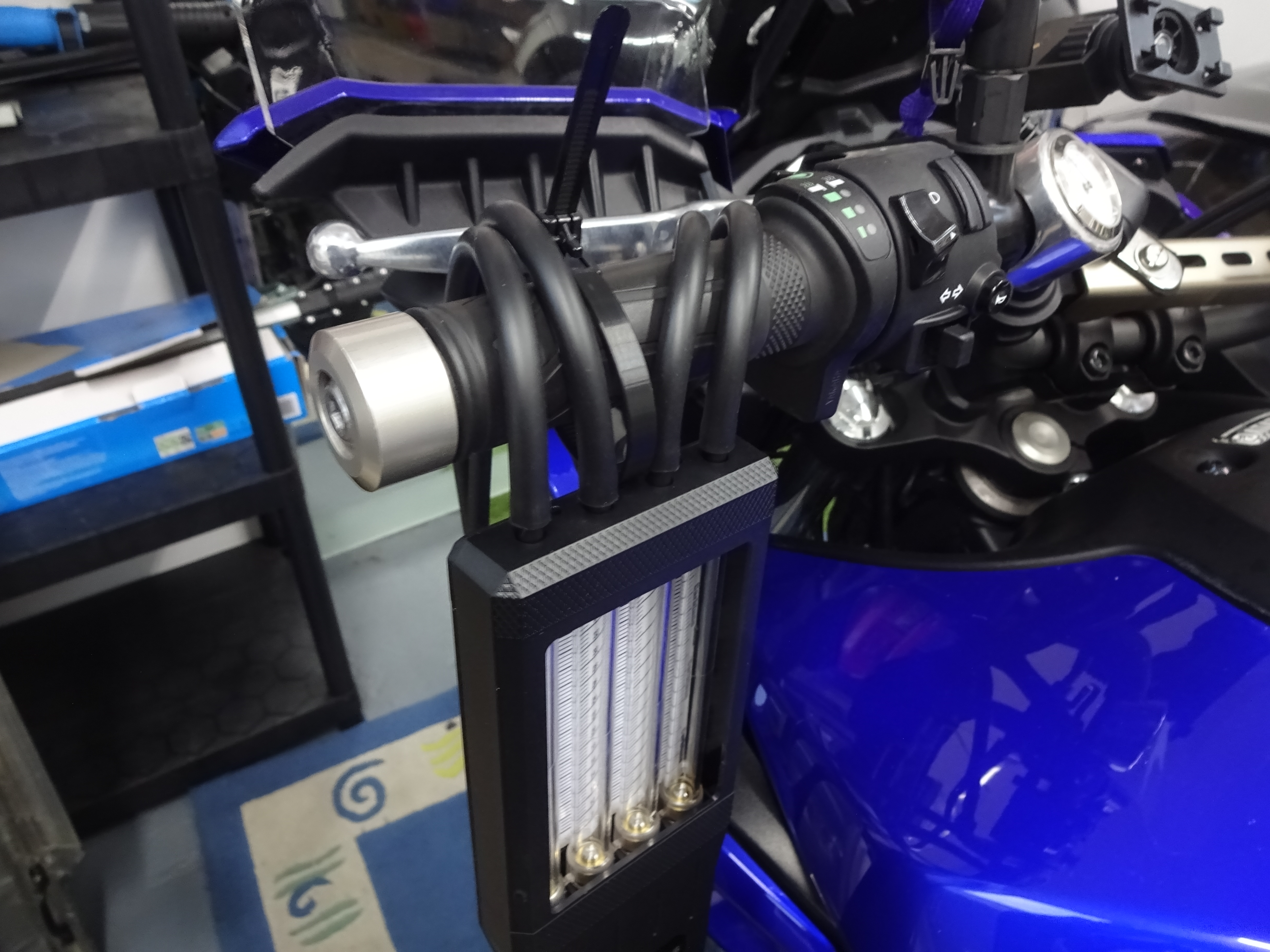 Guage hanging from handlebar